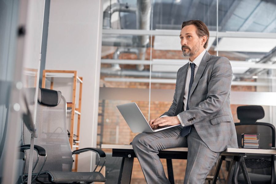 handsome-businessman-using-modern-laptop-at-work-2021-09-03-14-18-33-utc.jpg